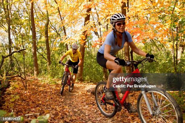 mountain biking on a forest trail - mountain biker stock pictures, royalty-free photos & images