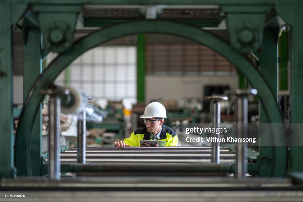 Male engineer and tablet working at manufacturing factory.