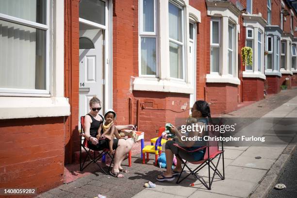 People enjoy the hot weather outside their homes on July 11, 2022 in Liverpool, United Kingdom. Britain will experience a heatwave this week as...