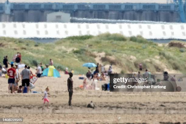 Heat haze shimmers over Crosby Beach as people relax in the warm weather on July 11, 2022 in Liverpool, United Kingdom. Britain will experience a...