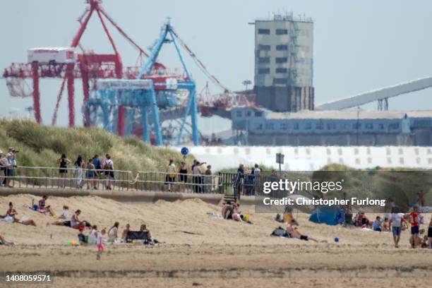Heat haze shimmers over Crosby Beach as people relax in the warm weather on July 11, 2022 in Liverpool, United Kingdom. Britain will experience a...