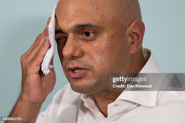 Former Health Minister Sajid Javid mops his brow while launching his bid to be the next Conservative Party Leader on July 11, 2022 in London,...