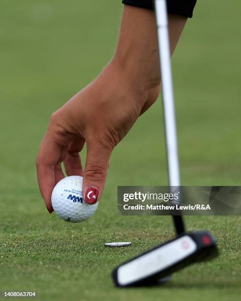 Deniz Kaya of Turkey places her ball on the 13th green during Day One of the The Junior Open Championship at Monifieth on July 11, 2022 in Monifieth,...