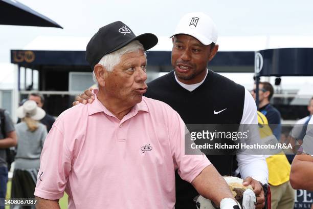 Lee Trevino interacts with Tiger Woods of the United States on the first tee during the Celebration of Champions prior to The 150th Open at St...