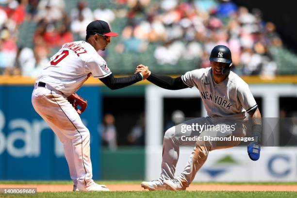 Andrés Giménez of the Cleveland Guardians helps up Gleyber Torres of the New York Yankees during the fifth inning of game one of a doubleheader at...