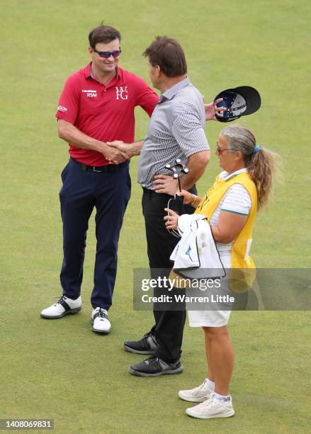 Sir Nick Faldo of England and Caddie Fanny Sunesson talks to Zack Johnson of The United States on the 18th during the Celebration of Champions...