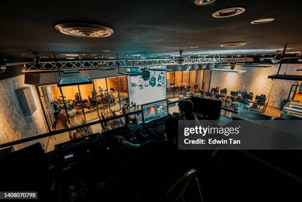 asian esports event crew working at backstage with control panel on stage lighting , sound system and lighting effect - backstage crew stock pictures, royalty-free photos & images