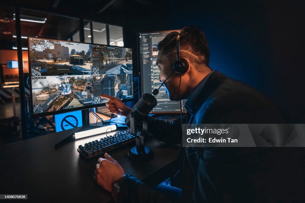 Excited Asian Chinese Esports Game Host Streamer online live streaming hosting in game room with VoIP and instant messaging social platform.