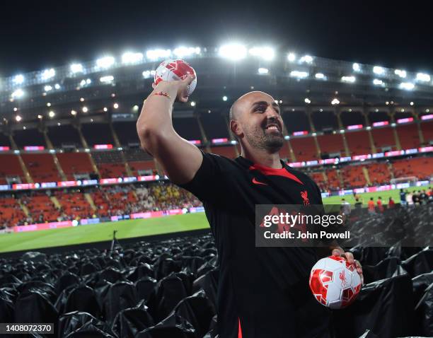 Jose Enrique ex Liverpool player throws balls into the crowd at the end of an open training session in the Rajamagala National Stadium on July 11,...