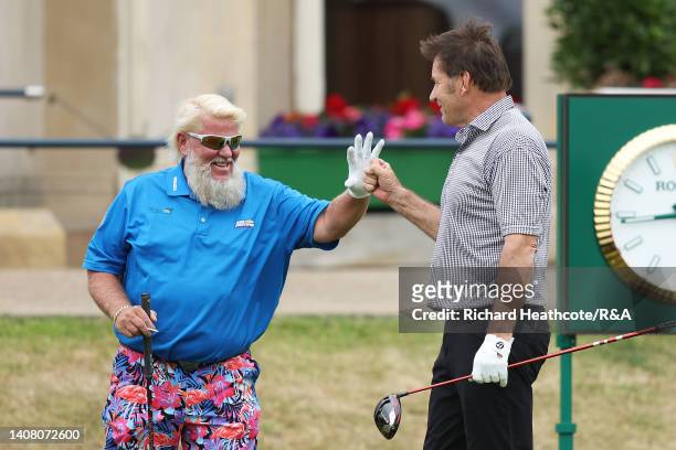 John Daly of The United States and Sir Nick Faldo of England interact on the first tee during the Celebration of Champions prior to The 150th Open at...