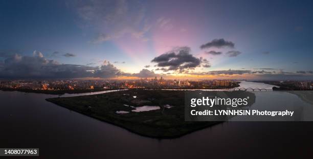 welcome to haikou free trade port2，an aerial view of haikou city from haikou jiangdong new area - haikou stockfoto's en -beelden