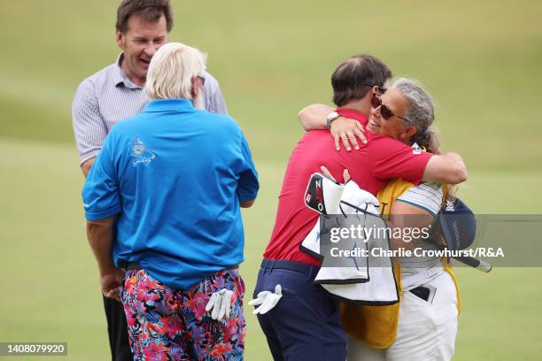 Zach Johnson of the United States, John Daly of the United States, Sir Nick Faldo of England and Fanny Sunesson embrace on the 18th hole during the...