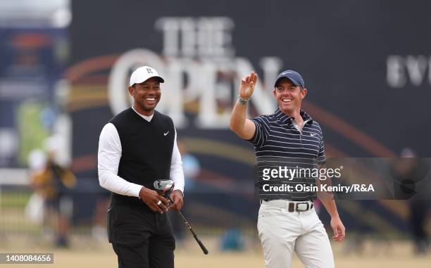 Tiger Woods of The USA and Rory McIlroy of Northern Ireland on the 18th fairway during the Celebration of Champions prior to The 150th Open at St...