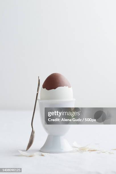 chocolate egg on white eggstand holder - hard boiled candy stock pictures, royalty-free photos & images