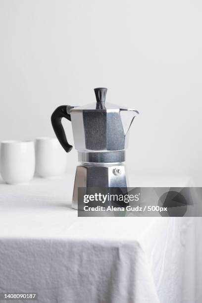 classic aluminium coffee maker on white table - heritage classic fotografías e imágenes de stock