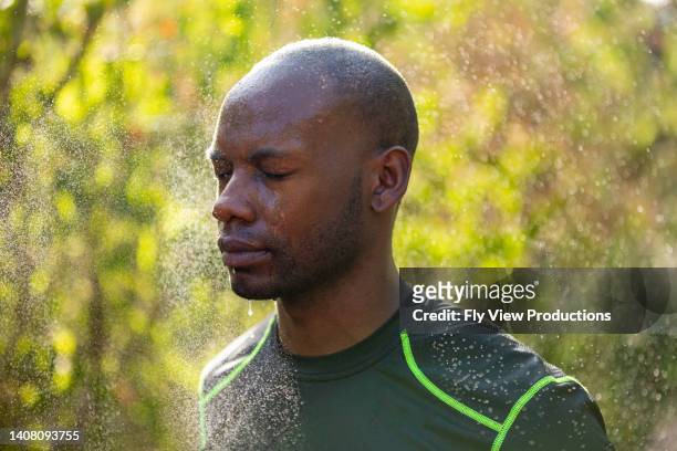 man cooling down after exercising outdoors - running refreshment stock pictures, royalty-free photos & images