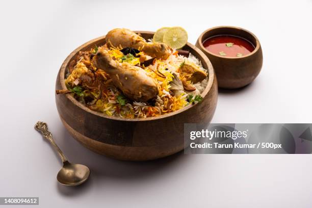 high angle view of food in bowl on white background,cuttack,odisha,india - biryani stock-fotos und bilder