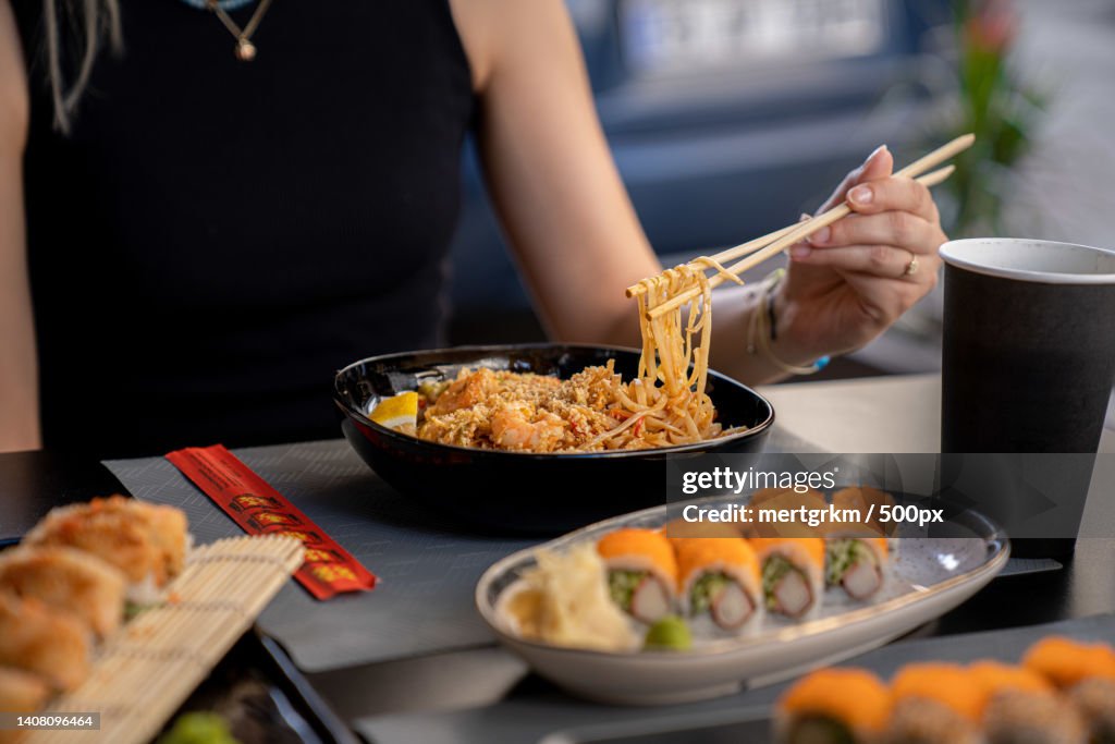 Midsection of woman eating food at table,Turkey