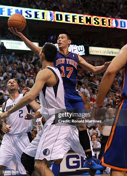 Jeremy Lin of the New York Knicks takes a shot against Yi Jianlian of the Dallas Mavericks at American Airlines Center on March 6, 2012 in Dallas,...