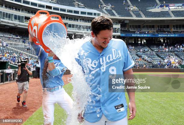 Vinnie Pasquantino of the Kansas City Royals is doused with water by Bobby Witt Jr. #7 after the Royals defeated the Detroit Tigers 3-1 to win game...