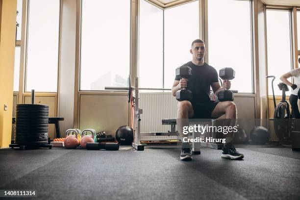 man training with dumbbells - weight bench stock pictures, royalty-free photos & images