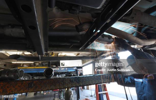 Luis Benitez welds a new catalytic converter onto a Chevrolet Silverado at Johnny Franklin's Muffler on July 11, 2022 in San Rafael, California....