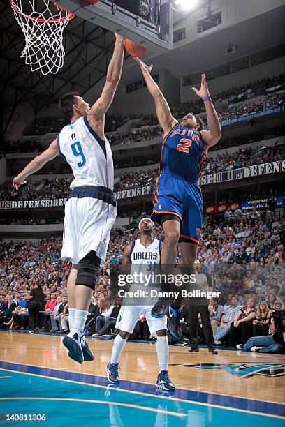 Landry Fields of the New York Knicks goes in for the layup against Yi Jianlian of the Dallas Mavericks on March 6, 2012 at the American Airlines...