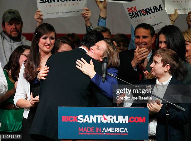 Republican presidential candidate, former U.S. Sen. Rick Santorum is hugged by his wife, Karen Santorum, during a primary night party at the...