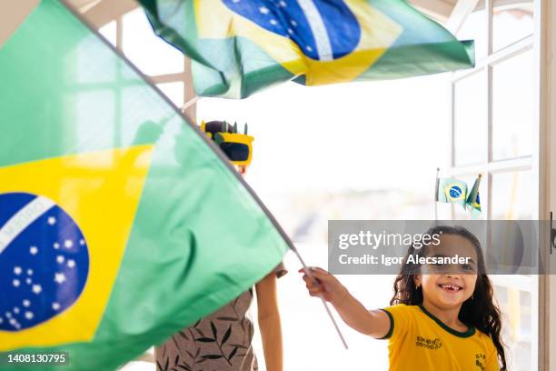 little girl cheering for brazil with flag - brazil girls supporters stock pictures, royalty-free photos & images