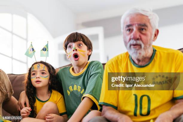 brazilian boy watching an amazing move - länderspiel stock pictures, royalty-free photos & images