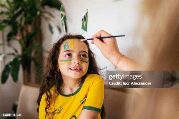 brazilian girl painting her face - female football fans stock pictures, royalty-free photos & images