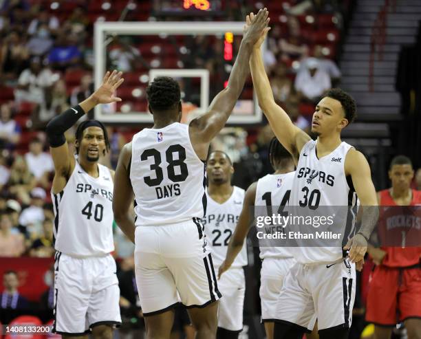 Darius Days of the San Antonio Spurs is congratulated by teammates Javin DeLaurier and Jordan Hall after Days hit a 3-pointer against the Houston...