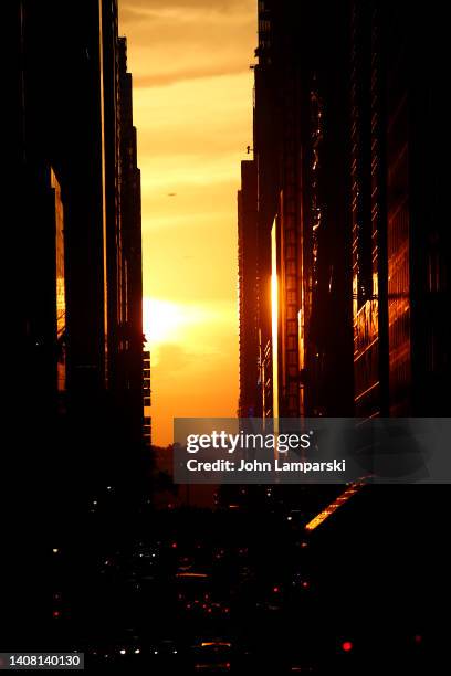 The sun sets on 42nd Street in Midtown during Manhattanhenge on July 11, 2022 in New York City.