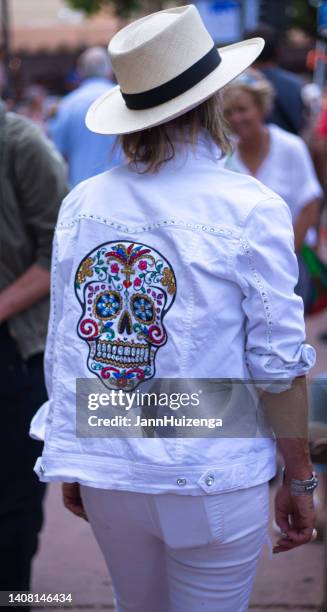 santa fe, nm: woman with chic jeweled skeleton jacket - jeweled jacket stock pictures, royalty-free photos & images