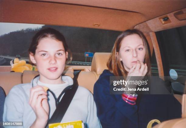 vintage friends, vintage teenagers, candid friends eating snacks, snacking in backseat of car y2k 2000s 1990s - 2000s style photos et images de collection