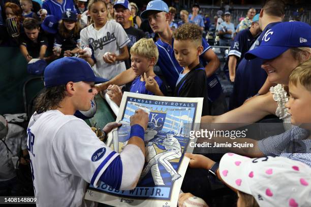 Bobby Witt Jr. #7 of the Kansas City Royals signs autographs after the Royals defeated the Detroit Tigers 6-3 to win game two of a doubleheader at...