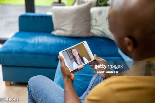 sick man staying at home and talking online to his doctor - telehealth visit stock pictures, royalty-free photos & images