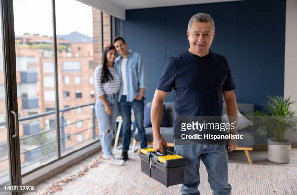 electrician making a house call at a couple's apartment - housing difficulties stock pictures, royalty-free photos & images