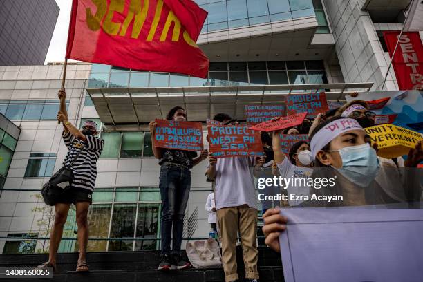 Filipinos take part in a protest against Chinese maritime activities in the disputed South China Sea, outside the Chinese Embassy on July 12, 2022 in...