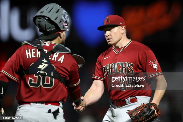 Mark Melancon of the Arizona Diamondbacks shakes hands with Jose Herrera after they beat the San Francisco Giants at Oracle Park on July 11, 2022 in...