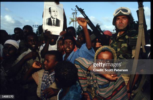 Soldier stands at a rally for faction leader General Aidid July 9, 1993 in Mogadishu, Somalia. Tension continues to escalate following the deadly...
