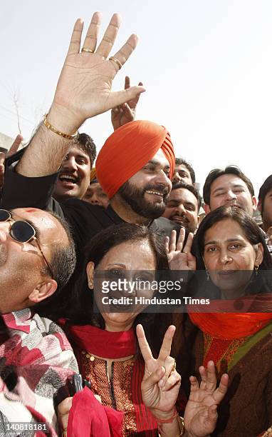 Amritsar MP Navjot Singh Sidhu, along with his wife and newly elected BJP MLA from Amritsar east Navjot Kaur Sidhu, celebrate the notable performance...