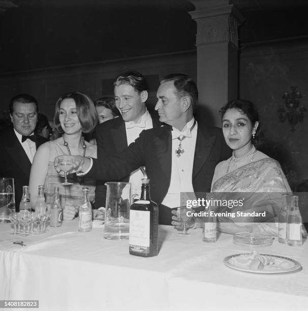 British actress Sian Phillips and her husband, British actor Peter O'Toole , with British film director and screenwriter David Lean , wearing his...