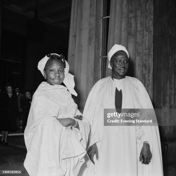 Nigerian politician Kashim Ibrahim wearing a traditional Nigerian agbada, with his daughter Fatima, as he attends his investiture at Buckingham...