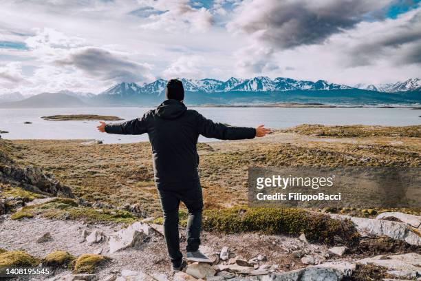 a man admiring the patagonian landscape near tierra del fuego - isla bridges - argentinien island stock pictures, royalty-free photos & images