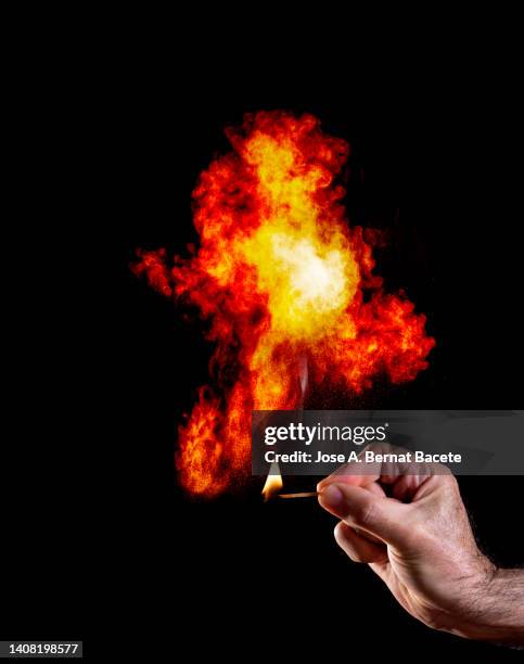 a man's hand with a match that causes an explosion with smoke. - finger blaster 個照片及圖片檔