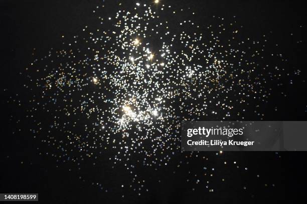 gold stars and silver stars on a black background. - silver sequins stock pictures, royalty-free photos & images