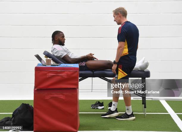 Arsenal physio Jordan Reece with Nuno Tavares during a training session at London Colney on July 11, 2022 in St Albans, England.