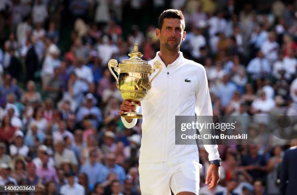 Novak Djokovic of Serbia holds the trophy following his victory against Nick Kyrgios of Australia during their Men's Singles Final match on day...