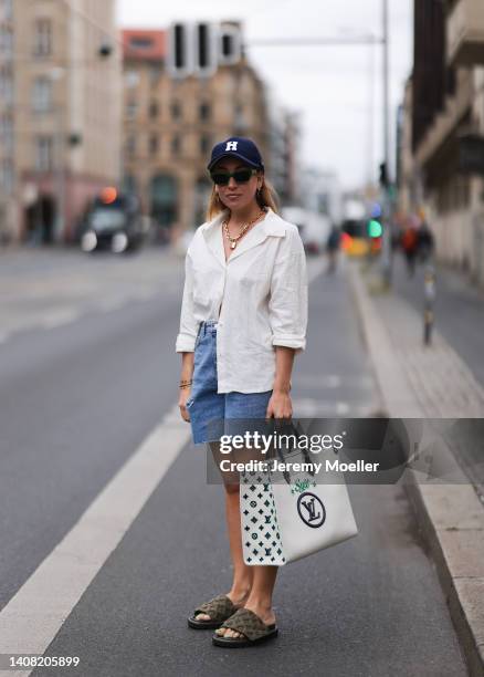 Sonia Lyson seen wearing a blue Highsnobity x New Era cap, a green striped sunglasses from Bottega Veneta, gold pendant necklace from Louis Vuitton,...